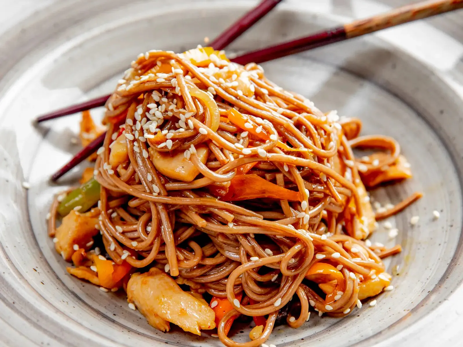 Stir-fried buckwheat noodles with chicken, colorful peppers and white sesame seeds at Hao Cafe，a Chinese Restaurant in Duarte